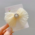 Close-up of cream mesh bow hair clip with faux pearl and rhinestone details - Hair Clip / Beige Apricot