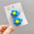 Detailed view of handmade plush flower hair clips in blue and yellow on a card - Lake Blue Duckbill Clip