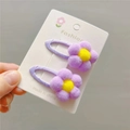 Close-up of plush purple flower hair clips with yellow center on display card - Light Purple BB Clip