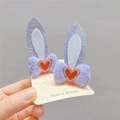 Detail showing plush rabbit ear hair clips with red rhinestone hearts and glitter texture - Light Purple Rabbit Ears Pair Clips