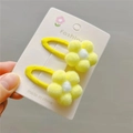 Detail of two yellow plush flower hair clips on a card with snap-on metal design - Light Yellow BB Clip