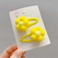 Detail of yellow plush flower hair clips on a white display card for girls - Bright Yellow BB Clip