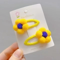 Detail of yellow plush flower snap clips with purple accents and hand-woven texture - Golden Yellow BB Clip