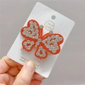 Macro detail of large butterfly hair clip with red base and sparkling white rhinestones - Dark Red