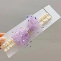 Detail eines Baby Stirnbands mit lila Netzsternschleife, Spitzengurt und Perlen - Lila