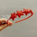 Détail d'un serre-tête rouge étoilé à paillettes avec des accents de maille argentée - Rouge