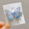 Close-up of butterfly hair clip with gradient tulle wings and silver glitter details - Silver Butterfly Hair Clip
