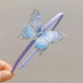 Detail of purple satin headband with a glittery blue-violet gradient butterfly and rhinestones - Silver Butterfly Headband
