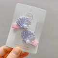 Close-up of glitter seashell hair clips with pearls and handmade ribbon for kids - Purple Shell Duckbill Clip / Purple