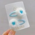Close-up of sky blue ribbon hair clips with white faux fur pom poms and heart crystal - Blue Heart