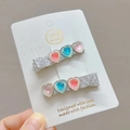 Close-up of handmade sparkling heart hair clips with pink and blue resin diamonds set on card - Light Multicolored (Pair)