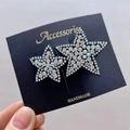 Detail of handmade sparkling star hairpins featuring premium rhinestones set on black base - White Star Duo Hair Clip
