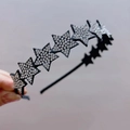 Detailed view of the sparkling rhinestone star elements on a non-slip fabric headband - White Small Star Headband