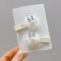 Detail of Christmas style hair clips featuring white plush balls and blue crystal antlers - Pearl Antler Faux Fur