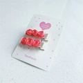 Detailed close-up of handmade red velvet rose hair clips on white jewelry display card - Watermelon Red (Pair)