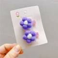Set of two purple plush flower hair clips with pink ribbon bases on a display card - Taro Purple Duckbill Clip