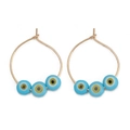 Detail of gold hoop earrings featuring three blue evil eye beads on a white background - Three Beads Style (BE1374GD09)