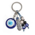 Detail of Turkish Evil Eye keychain with blue glass pendant and vintage metal feather - Feather and Blue Eye (BE1383BU05)