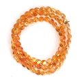 Macro detail of faceted amber glass beads with iridescent electroplated rainbow finish - Orange Iridescent (BT751GD09)