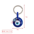 Blue glass evil eye keychain with silver metal ring and woven cord hanging detail - Center Hollow Eye Pendant Style (BE1363BU10)