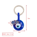 Golden Hamsa hand and blue Evil Eye keychain pendant with braided rope on white background - Red Decor Hamsa Hand Style (BE1363BU21)