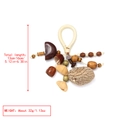 Macro detail of handmade natural nut shell pendant with woven rope and wooden beads - Mixed Nut Shell Wood Bead Pendant (5)