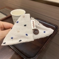 Close-up of beige linen hair claw with blue embroidered dots and brown button detail - Beige Coffee
