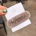 Dettaglio ravvicinato del fermaglio BB con strass scintillanti su cartoncino - Champagne
