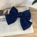 Close-up of navy blue oversized satin bow hair clip on a vintage background - Navy Blue Spring Clip