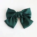 Close-up of a large dark green satin bow hair clip with a smooth glossy texture - Dark Green