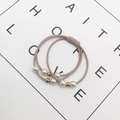 Detail of pink elastic hair bands with white faux pearls and gold beads on white background - Light Pink