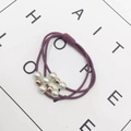 Detail of elastic hair ties featuring white faux pearls and gold metal beads set - Rose Red