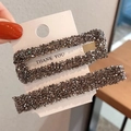 Sparkly grey rhinestone two-piece hair clip set on a white display card in hand - Rectangular Hollow And Strip Style (AB-170) / Black