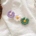 Close-up of triple daisy hair clip with purple white green petals and golden base - Purple White Green Daisy Combo