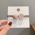 Detail van Morandi roze haarelastiekje met kralen en gouden rand op een displaykaart - Oudroze