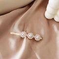 Detail of floral hair clip with pearl clusters on elegant champagne satin fabric - Triple Pearl Flower Cluster Hair Clip (AB-28-9)
