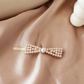 Detail of elegant gold hairpin with ivory pearls on soft silk fabric background - Bowknot Long Bar Pearl Clip (AB-28-10)