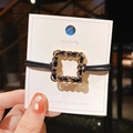 Elegant Korean style gold chain square hair tie with black leather braid on display card - Square Style