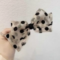 Detailed view of oversized polka dot organza bow hair clip with layered soft tulle texture - Beige Hair Clip
