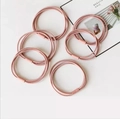 Detail of 6-piece pink elastic hair ties featuring a durable multi-strand braided design - Pink