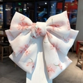 Elegant large chiffon bow hair clip with floral pattern on a white display card - White