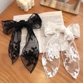 Elegant pair of lace bow hair clips with floral embroidery on an open book background - Hair Clip (Duckbill Clip)