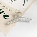 Dettaglio di un grande fermaglio per capelli in acrilico trasparente con molla dorata - Trasparente