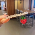 Detail of crystal hair clip with a sweet red strawberry pendant and golden base - Strawberry Bobby Pin