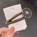 Baroque style gold chain hair clip with large pearl and sparkling crystals on card - Round