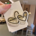 Detail of elegant gold double heart hair clip with white faux pearls and black accents - Heart Pearl