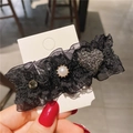 Detail of vintage black lace hair clip featuring pearls, rhinestones and green emerald stone - Lace Heart