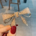 Barrette élégante en forme de nœud doré avec perles blanches et strass brillants - Nœud Doré
