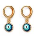 Detailed view of golden hoop earrings with blue enamel evil eye charms on a white background - Blue
