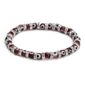 Macro shot of dark red Evil Eye beads with sparkling crystal spacers on elastic bracelet - Purple